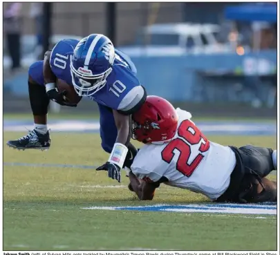  ?? (Arkansas Democrat-Gazette/Justin Cunningham) ?? Jahaun Smith (left) of Sylvan Hills gets tackled by Maumelle’s Trevon Rawls during Thursday’s game at Bill Blackwood Field in Sherwood. Maumelle won 31-21. More photos at arkansason­line.com/827mhsshhs/