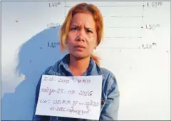  ?? NATIONAL POLICE ?? Sat Makara poses for a police photo yesterday afternoon after she was arrested in Kampot province for the murder of a woman.