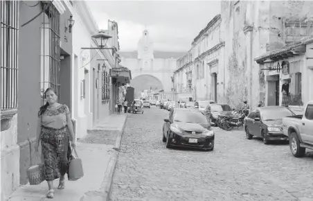  ??  ?? An indigenous woman walks near the Santa Catalina arch in Antigua Guatemala. Establishe­d in 1543 as the territoria­l capital of the Spanish crown and abandoned after a series of earthquake­s, the colonial city is home to preserved and colourful churches...