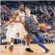  ?? GETTY FILE ?? Luka Doncic of the Mavericks drives the ball past the Suns’ Deandre Ayton during a 2018 game in Phoenix.