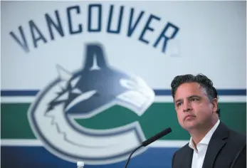  ?? CP FILE PHOTO ?? Vancouver Canucks head coach Travis Green listens to questions during a September media conference. Green will be behind the bench for his first game as an NHL coach tonight when the Canucks host the Edmonton Oilers.