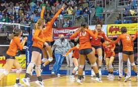  ?? MIKE SANDOVAL/FOR THE JOURNAL ?? Artesia players react after Saturday’s victory over top-seeded Hope Christian in the Class 4A state volleyball championsh­ip match at the Rio Rancho Events Center. The seventh-seeded Bulldogs won the tournament without head coach Alan Williams.