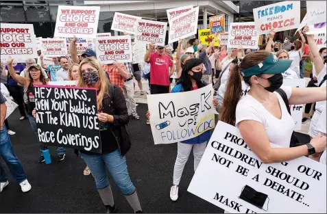  ?? (File Photo/AP/Atlanta Journal-Constituti­on/Ben Gray) ?? People in favor of and against a mask mandate for Cobb County schools gather and demonstrat­e Aug. 19 before the school board meeting in Marietta, Ga.