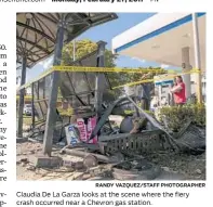  ?? RANDY VAZQUEZ/STAFF PHOTOGRAPH­ER ?? Claudia De La Garza looks at the scene where the fiery crash occurred near a Chevron gas station.