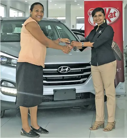  ?? Photo: Ashna Kumar ?? Nestle promotion grand prize winner Elenoa Rasoki (left), with Nestle brand activation manager Monisha Prasad during the handover of the vehicle at the Carpenters Hyundai showroom in Walu Bay, Suva, on March 16, 2018.