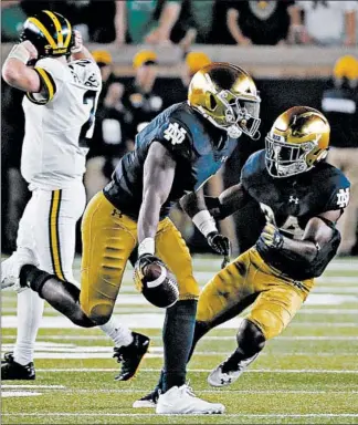  ?? PAUL SANCYA/AP ?? Te’von Coney celebrates his recovery of a Shea Patterson fumble in the final minute that sealed the win.