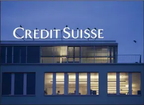  ?? (AP) ?? Birds sit on the sign over a Credit Suisse bank building in the Brunau district of Zurich, Switzerlan­d.