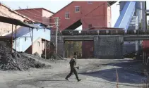  ??  ?? A MINER walks at a coal mine from the state-owned Longmay Group on the outskirts of Jixi, in Heilongjia­ng province, China, Oct. 24, 2015.