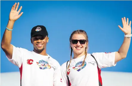  ?? LYLE ASPINALL/FILES ?? Olympic medallists Akeem Haynes and Erica Wiebe wave after disembarki­ng a Dreams Take Flight jet in Los Angeles last October. Haynes, who grew up poor before his big Olympic break, joined his hometown chapter of Dreams Take Fight Calgary for the trip...