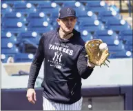  ?? John Raoux / Associated Press ?? New York Yankees manger Aaron Boone plays catch with one of the players during a spring training workout on Monday in Tampa, Fla.