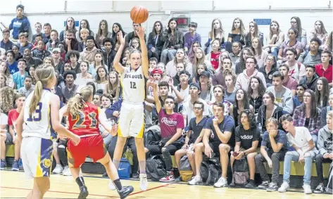  ?? BOB TYMCZYSZYN/STANDARD STAFF ?? Sir Winston Churchill's Janee Harrison (12) makes a three-point shot against Greater Fort Erie Secondary School during the opening day of play at the 18th annual Standard Girls Basketball Tournament.