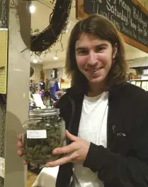  ??  ?? Colton Curtis sells his berry blossom brand smokable hemp at the very hempy holidays event at the Country home and Farm store in Pittsboro, North Carolina.