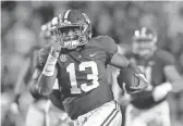  ?? AP ?? Alabama quarterbac­k Tua Tagovailoa (13) rushes on a 44 yard touchdown carry in the second half in Baton Rouge, La., Saturday.