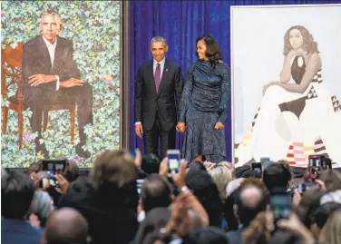  ?? Andrew Harnik / Associated Press ?? Former President Barack Obama and former first lady Michelle Obama stand together at the Smithsonia­n’s National Portrait Gallery in Washington as their official portraits are unveiled.