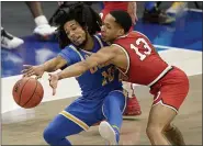  ?? TONY DEJAK — THE ASSOCIATED PRESS ?? UCLA’s Tyger Campbell (10) and Ohio State’s CJ Walker (13) battle for the ball in the second half Dec. 19 at Rocket Mortgage FieldHouse.