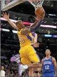  ?? GUS RUELAS — ASSOCIATED PRESS FILE ?? Los Angeles Lakers guard Kobe Bryant (24) gets by Philadelph­ia 76ers center Spencer Hawes, back right, for the reverse layup Jan. 1, 2013, in Los Angeles.