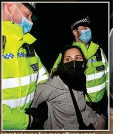  ??  ?? Marched away: Two male officers arrest a female demonstrat­or at the vigil