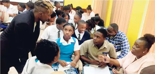  ??  ?? Team leader Winsome Minott and guest speaker Damien Williams address the students and teachers who attended the second sensitizat­ion workshop, held on February 22 for the Katalyxt Youth Innovators’ Competitio­n.