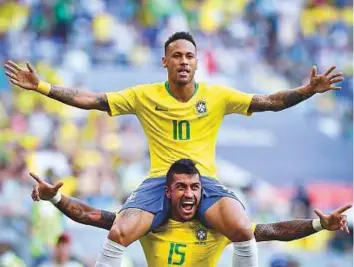  ?? AFP ?? Neymar celebrates with Brazil’s midfielder Paulinho after scoring the opening goal during the round of 16 football match between Brazil and Mexico at the Samara Arena in Samara.