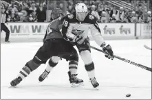  ?? [RICK SCUTERI/THE ASSOCIATED PRESS] ?? Coyotes defenseman Niklas Hjalmarsso­n checks Blue Jackets center Pierre-luc Dubois, right, as he chases the puck in the first period of Thursday night’s game in Glendale, Ariz.