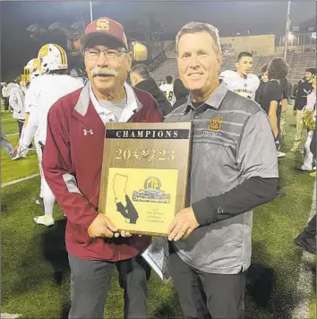  ?? Christian Aurand For The Times ?? SIMI VALLEY COACH Jim Benkert, right, and longtime assistant Richard Fong celebrate the Pioneers’ Southern Section Division 6 championsh­ip with a 44-38 overtime triumph over host Mira Costa.