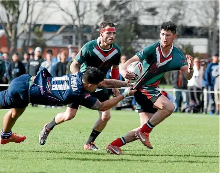  ??  ?? Whiti Te Ra fullback Himiona Henare is grabbed by the shirt during his side’s 26-24 win over Te Aroha in the Wellington rugby league final on Saturday.