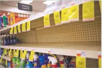  ?? DAVID GOLDMAN/ASSOCIATED PRESS ?? Shelves where disinfecta­nt wipes and sprays are usually displayed sit empty in a pharmacy Wednesday in Providence, R.I. Widespread fears about coronaviru­s have caused acute shortages of hand sanitizer, creating a cottage industry online.