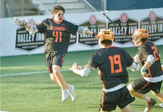  ?? AMY DAVIS/BALTIMORE SUN PHOTOS ?? McDonogh’s Brendan Millon, left, celebrates with teammates Will Aspen (19) and Paul McLucas after scoring the winning goal against Boys’ Latin with one second remaining in the MIAA A Conference semifinal at Navy-Marine Corps Memorial Stadium in Annapolis.