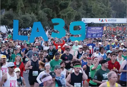  ?? DAVID CRANE — STAFF PHOTOGRAPH­ER ?? Runners head out from Dodger Stadium early Sunday morning at the starting line for the 39th Los Angeles Marathon.