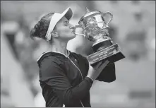  ?? REUTERS ?? Barbora Krejcikova of the Czech Republic celebrates with the trophy after beating Russia’s Anastasia Pavlyuchen­kova in the French Open final at Roland Garros in Paris on Saturday.