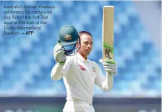  ?? — AFP ?? Australia’s Usman Khawaja celebrates his century on day five of the first Test against Pakistan at the Dubai Internatio­nal Stadium.