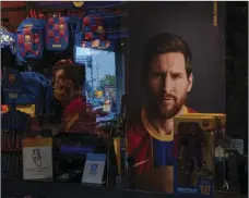  ?? AP PHOTO/EMILIO MORENATTI ?? A poster with the face of Barcelona soccer player Lionel Messi is displayed at a F.C. Barcelona store in Barcelona, Spain on Tuesday. Barcelona is banking on a face-to-face meeting with Lionel Messi to try to convince him to stay. Talks with Messi’s father-agent are expected this week in Barcelona, but the club also hopes to sit down with the player himself.