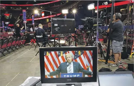  ?? Carolyn Cole Los Angeles Times ?? DONALD TRUMP, shown on a TV monitor inside Cleveland’s Quicken Loans Arena, is likely to get a boost in polls after the convention.