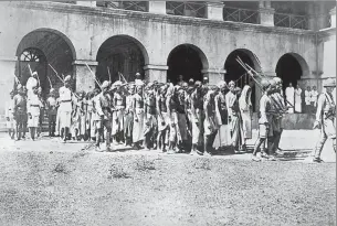  ?? GETTY IMAGE ?? A 1925 photo of Mappila prisoners going to trial in Calicut for agitating against the British. In 192122, during a rebellion against the British as well as the feudal class – mostly Hindus – as many as 2,400 Mappilas were killed and nearly 40,000...