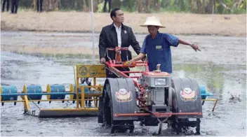  ?? — Reuters ?? Prime Minister Prayuth Chan-ocha rides on a tractor at a farmer school in Suphan Buri province on September 18.