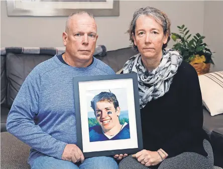  ?? JEFFREY T. BARNES FOR USA TODAY ?? Anne and Bill Benedict at their home in Hamburg, New York, with a photo of their son Matthew, a multisport high school star who died by suicide this past summer.