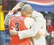  ?? Lori Van Buren / Albany Times Union ?? Fairfield’s Tyler Nelson gets a hug from head coach Sydney Johnson after he leaves the game before a loss to Iona in the MAAC Tournament’s championsh­ip game at the Times Union Center on March 5.