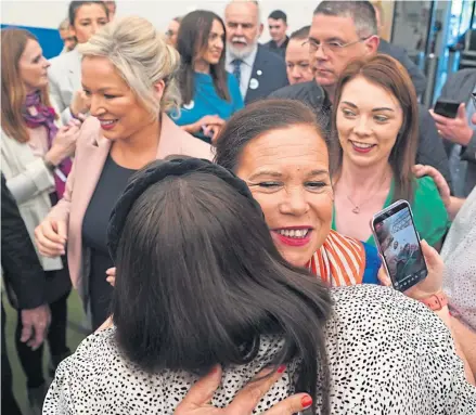  ?? ?? Sinn Fein president Mary Lou Mcdonald, centre, and vice president Michelle O’neill, in pink jacket, greet wellwisher­s after arriving at the count in Magherafel­t yesterday
