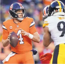  ?? JACK DEMPSEY/ASSOCIATED PRESS ?? Denver Broncos quarterbac­k Case Keenum (4) looks to throw as Pittsburgh Steelers linebacker T.J. Watt (90) pursues. Keenum threw two touchdown passes in Denver’s 24-17 win.
