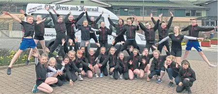  ??  ?? JUMPING FOR JOY: Orkney Gymnastics Club with the minibus they won in The P&J competitio­n last year