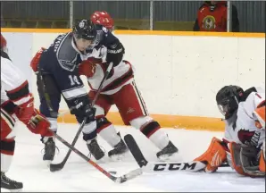  ?? NEWS PHOTO RYAN MCCRACKEN ?? Medicine Hat Cubs forward Jesse Barsness battles for a loose puck in front of Ponoka Stampeders goaltender Keenan Starkell during Sunday’s Heritage Junior Hockey League game at the Kinplex.