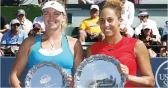 ??  ?? STANFORD: Madison Keys, right, of the United States, holds the winner’s plate next to Coco Vandeweghe, left, of the United States, with the runner-up plate, after the final in the Bank of the West Classic tennis tournament in Stanford, Calif. — AP
