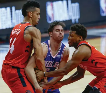  ?? RICK MADONIK TORONTO STAR ?? One ball isn’t meant to be shared by three players: the 76ers’ T.J. McConnell between Toronto’s Danny Green, left, and Kyle Lowry.