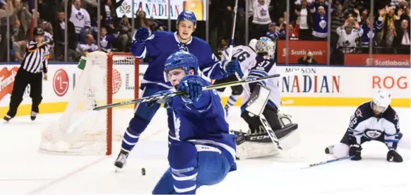  ?? GRAIG ABEL/GETTY IMAGES ?? Jake Gardiner triggered the celebratio­n at the Air Canada Centre, scoring at 2:29 of OT past Jets goalie Connor Hellebuyck on Tuesday night — after William Nylander had tied it in the third.