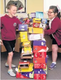  ??  ?? Pupils with some of the dozens of egg boxes they collected