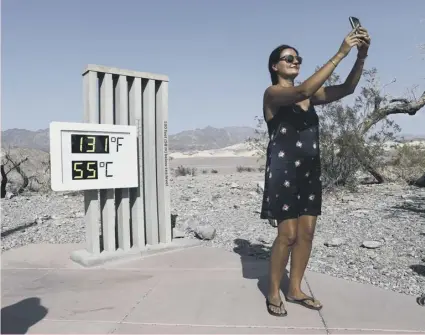  ??  ?? 0 An unofficial thermomete­r shows record-breaking heat at Furnace Creek Visitor Center in Death Valley, California