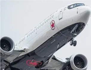  ?? DARRYL DYCK THE CANADIAN PRESS FILE PHOTO ?? Air Canada and WestJet, two Canadian airlines dealing with the grounding of the Boeing 737 Max jets, say they have re-assigned other planes to accommodat­e travellers.