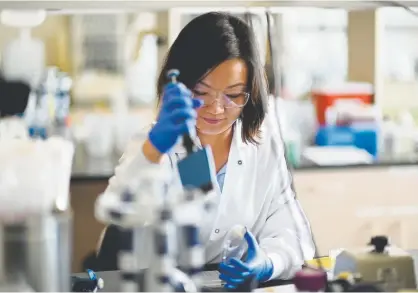  ?? Hyoung Chang, The Denver Post ?? Scientist Qi Liu works in a Sharklet Technologi­es laboratory at the Fitzsimons Innovation Community, a bioscience­s facility on the University of Colorado Anschutz Medical Campus in Aurora. The entire campus, at the site of the former Fitzsimons Army base, pumps about $7 billion into the economy and employs about 23,000 people.