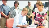  ?? Ned Gerard / Hearst Connecticu­t Media ?? Gov. Ned Lamont signs a bill on Friday that will implement new policies designated to support growth of the state’s shellfish industry.