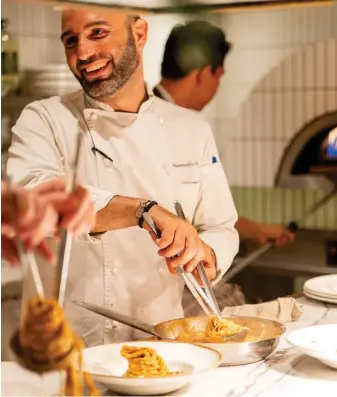  ?? ?? ALESSANDRO D’AMICO, WHILE PLATING SPAGHETTON­E IN SALSA DI GAMBERI